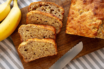 Homemade Banana Bread on a wooden board, top view. Close-up.