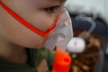 A nebulizer and other medical devices are visible in the blurred background. The process of...