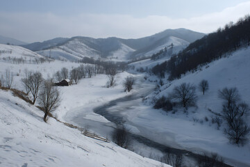 Fototapeta premium Frozen River Snaking Through Snowy Valley Hills