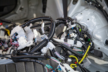 Wires, connectors, modules, and connections from a new car wiring harness to replace the old wiring in a vehicle