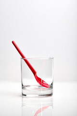 Empty glass with plastic spoon