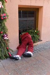  Grodno, Belarus, January 3, 2025. Santa Claus climbs into a window.                              