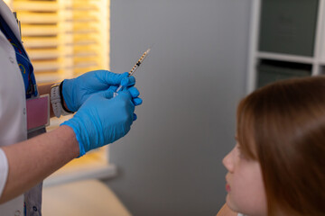 A dedicated healthcare professional prepares a vaccine for a patient in a clinic setting