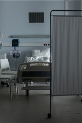 Fototapeta premium A serene hospital room with a patient bed and privacy screen for comfort and support