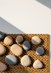 Stone and Wood Pebbles Collection on Woven Rattan Mat