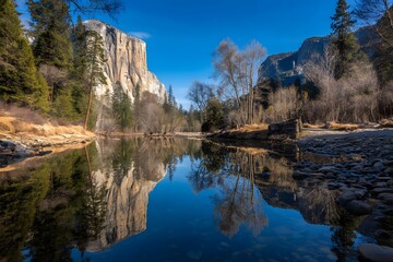 Yosemite Reflections: A serene shot showcases the majestic landscape of Yosemite Valley, with towering rock formations mirrored in the still waters of the river below, all under a clear.