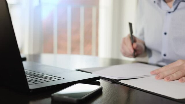 female doctor working on computer
An employee in an office signs documents.