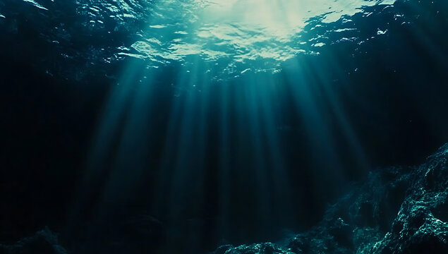 The underwater scene features deep blue water, with sunlight shining through the surface and creating ripples on its top layer. 