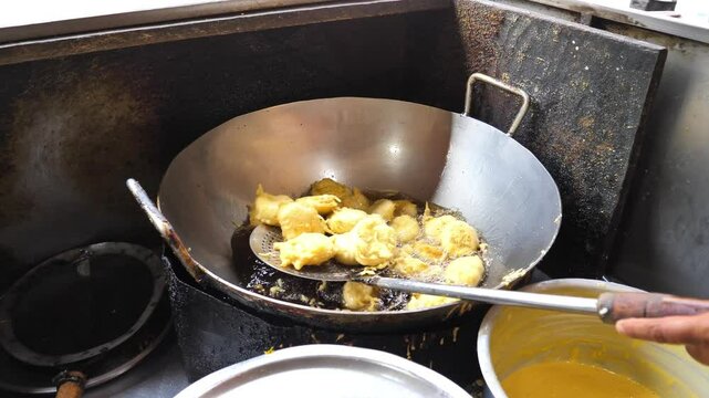 Frying Mumbai Vada Pav in Hot Oil in a Big Kadai

