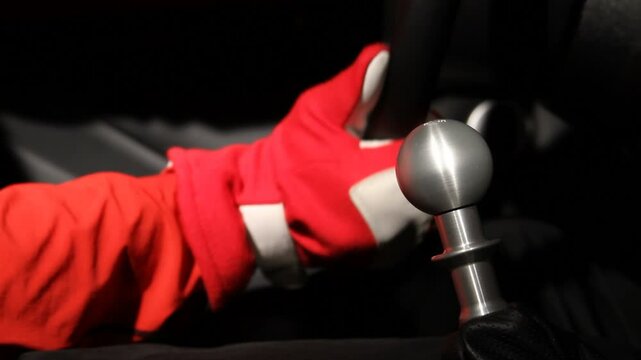 Driver Shifting Gears in Racing Gloves