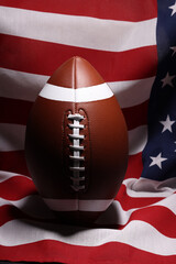 American football ball and USA flag. Sport game. Super bowl in US. Football ball Close Up macro...