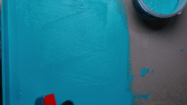 applying waterproofing with a roller and brush to the surface