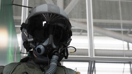 A fighter pilot helmet equipped with a dark visor and oxygen mask.