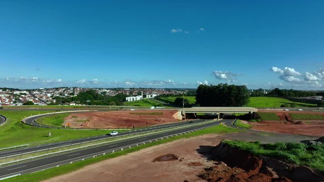 High-angle aerial view of highway infrastructure development. Construction of the access road to Shopping Botucatu, on the Teacher Joao Hipolito Martins Highway (SP-209). 12-24-2024