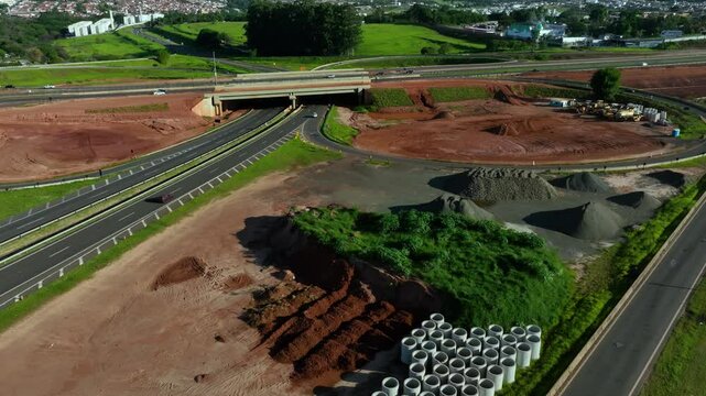 High-angle aerial view of highway infrastructure development. Construction of the access road to Shopping Botucatu, on the Teacher Joao Hipolito Martins Highway (SP-209). 12-24-2024
