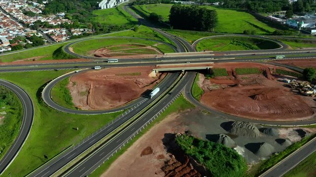 High-angle aerial view of highway infrastructure development. Construction of the access road to Shopping Botucatu, on the Teacher Joao Hipolito Martins Highway (SP-209). 12-24-2024