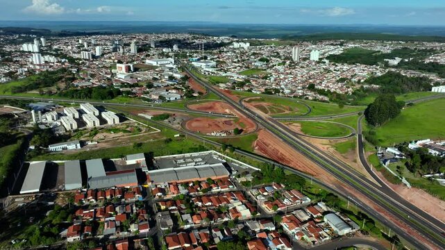 High-angle aerial view of highway infrastructure development. Construction of the access road to Shopping Botucatu, on the Teacher Joao Hipolito Martins Highway (SP-209). 12-24-2024