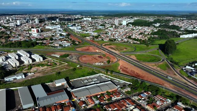 High-angle aerial view of highway infrastructure development. Construction of the access road to Shopping Botucatu, on the Teacher Joao Hipolito Martins Highway (SP-209). 12-24-2024