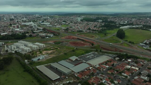 High-angle aerial view of highway infrastructure development. Construction of the access road to Shopping Botucatu, on the Teacher Joao Hipolito Martins Highway (SP-209). 01-16-2025