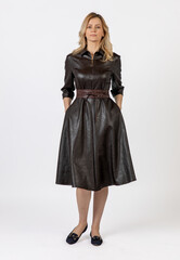 Fototapeta premium Elegant Woman Wearing Dark Coat in Studio Portrait Setting