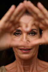 Close-Up Portrait of Woman Framing Her Face with Hands