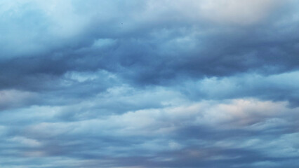 Obraz premium On a rainy April evening, the clouds paint a dramatic scene in the sky, their shifting forms and moody hues embodying nature's raw beauty and fleeting artistry