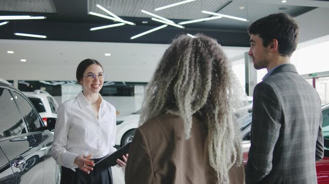Car sales associate engages with customers at a modern dealership during a busy afternoon, showcasing the latest vehicle features and options for purchase