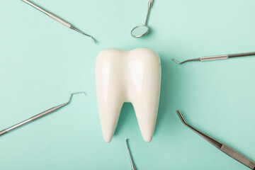 Dentist tools on a blue background. Dentist Concept.Teethcare, dental health concept. Means to care for the oral cavity. Dental model and dental equipment. Dental hygiene. Space for text. Copy space.