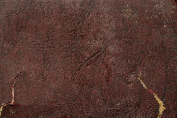 Background of brown old cracked leather close up, the skin is grainy dusty