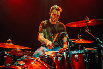 Drummer playing drums during live performance on stage
