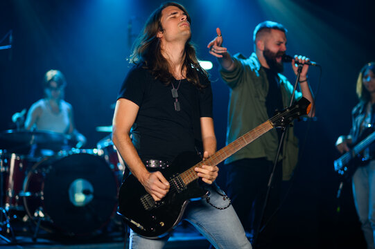 Rock band performing live on stage with passion and energy