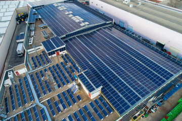 Solar panels covering industrial building roof generating clean energy