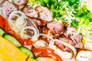 Grilled chicken platter with fresh vegetables and toppings