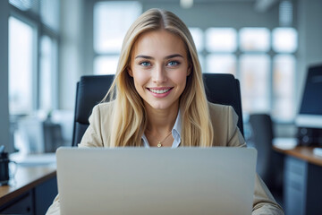 Portrait of a young blonde woman working in an office.