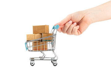 Online shopping concept.Cardboard box and shopping bags in a trolley isolated on white background....