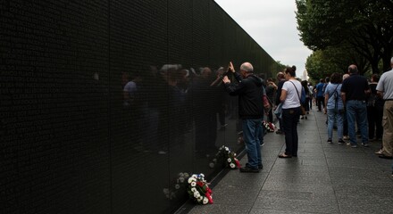 Visitors paying respects at Vietnam Veterans Memorial  