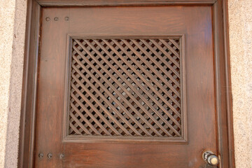 Close-up of an intricate wooden lattice detail, highlighting craftsmanship, texture, and...
