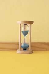 Hourglass with a flowing blue sand inside