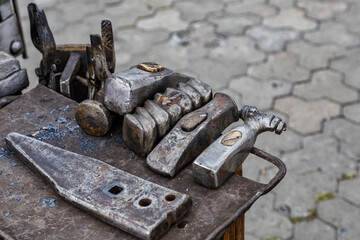 Blacksmith tools on the outdoors.Hand anvil. hummers all blacksmith tools in forge.