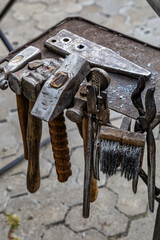 Blacksmith tools on the outdoors.Hand anvil. hummers all blacksmith tools in forge.