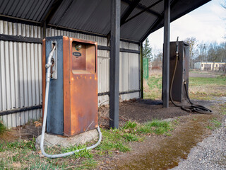 Old gas station with destroyed petrol pumps. Spring time.