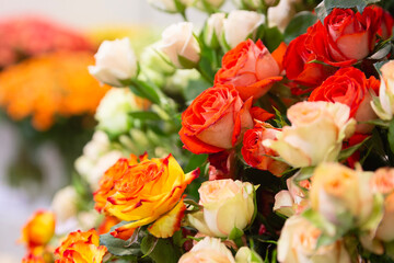 Beautiful roses of various colors in the window of a flower shop