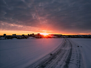 An aerial view of the Dettah Ice Road at sunset in Yellowknife, Northwest Territories, Canada