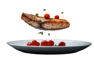 a beautifully presented piece of salmon fillet hovers above a white plate accompanied by vibrant cherry tomatoes creating an artistic culinary display
