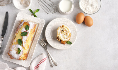 Serving option for Finnish pancake in roll with cream on white plate with ingredients, In Top View, copy space