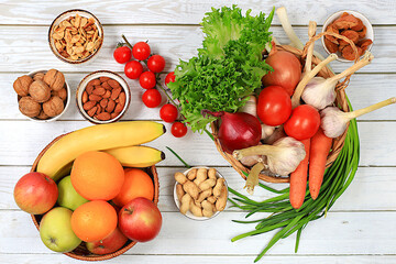 Healthy balanced diet with dietary ingredients, fresh vegetables, fruits, nuts and cheese in baskets for weight loss, source of vitamin C, healthy lifestyle and detox diet concept,harvest