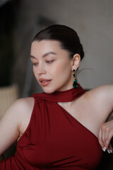 Beautiful pregnant woman in long red dress in sand. Big pregnant belly. Pretty brunette woman waiting child. Lady in room with chandeliers and portieres, fairy tale