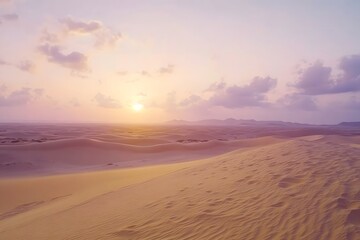 A scenic view of sand dunes under a pastel sky with the sun setting in the distance landscape scene