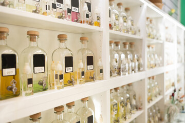 Bottles of fragrances for refilling into small bottles on display in perfume shop
