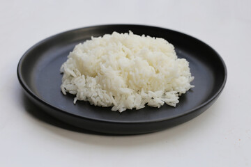 Cooked rice on black plate